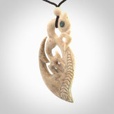 Whalebone double manaia pendant with paua shell, hand carved in New Zealand for NZ Pacific. Maori design pendant for sale online.